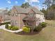 Spacious two-story brick home with manicured lawn and walkway, ideal for families at 5928 Terrington Ln, Raleigh, NC 27606