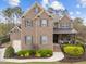 Two-story brick home with landscaped yard, gray shutters, covered porch, and attached two-car garage at 5928 Terrington Ln, Raleigh, NC 27606