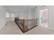 Upstairs hallway with carpet floors and views into other rooms at 5928 Terrington Ln, Raleigh, NC 27606