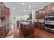Gourmet kitchen features stainless appliances, granite counters, ample cabinets, and hardwood floors at 5928 Terrington Ln, Raleigh, NC 27606
