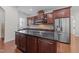 Modern kitchen features dark cabinets, granite countertops, stainless steel appliances, and a central island at 5928 Terrington Ln, Raleigh, NC 27606