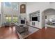 Spacious living room with hardwood floors, fireplace, large windows, and custom built-ins at 5928 Terrington Ln, Raleigh, NC 27606