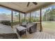 A screened porch with wooden floors overlooking a wooded yard at 5928 Terrington Ln, Raleigh, NC 27606