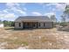 Rear exterior view of home with large yard and screened in porch at 609 Tuscany Cir, Princeton, NC 27569