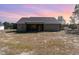 Rear exterior view of home with large yard and screened in porch at 609 Tuscany Cir, Princeton, NC 27569
