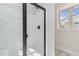 Bathroom featuring glass walk-in shower and window at 609 Tuscany Cir, Princeton, NC 27569