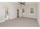 Bedroom with carpet flooring, ceiling fan and view to bathroom with double vanity at 609 Tuscany Cir, Princeton, NC 27569