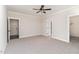 Spacious carpeted bedroom with ceiling fan, and walk-in closet at 609 Tuscany Cir, Princeton, NC 27569