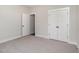 Bedroom featuring gray carpet and closet and en suite bath at 609 Tuscany Cir, Princeton, NC 27569