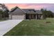 Inviting single-Gathering home featuring lush green lawn, covered porch, and two-car garage at 609 Tuscany Cir, Princeton, NC 27569