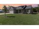 Inviting single-Gathering home features a well-maintained lawn and covered porch, bathed in a sunset glow at 609 Tuscany Cir, Princeton, NC 27569