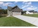 New single-Gathering home with two-car garage and spacious concrete driveway on a sunny day at 609 Tuscany Cir, Princeton, NC 27569