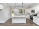 Modern kitchen with white cabinets, granite countertops, stainless steel appliances, and island at 609 Tuscany Cir, Princeton, NC 27569