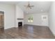 Bright living room featuring a fireplace, wood floors, and natural light from the window at 609 Tuscany Cir, Princeton, NC 27569