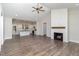 Spacious living room with vaulted ceiling, wood floors, and fireplace open to kitchen at 609 Tuscany Cir, Princeton, NC 27569