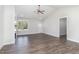 Open-concept living room with wood floors, ceiling fan and white walls offer great natural light at 609 Tuscany Cir, Princeton, NC 27569