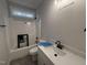 Bright bathroom featuring a tub/shower combo, white vanity, and modern fixtures at 612 Tuscany Cir, Princeton, NC 27569