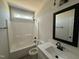 Bathroom with white vanity, framed mirror, tile flooring, and a shower-tub combo at 612 Tuscany Cir, Princeton, NC 27569