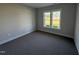 Neutral bedroom with carpeted flooring, a double window letting in natural light, and baseboard trim at 612 Tuscany Cir, Princeton, NC 27569