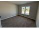 Carpeted bedroom with a large window providing natural light at 612 Tuscany Cir, Princeton, NC 27569