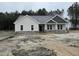 Charming new construction home with stone accents, covered entry, and professionally landscaped yard at 612 Tuscany Cir, Princeton, NC 27569