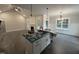 Well-lit kitchen with open floor plan, island sink, and decorative lighting fixtures at 612 Tuscany Cir, Princeton, NC 27569