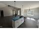 Modern kitchen featuring a center island, pendant lighting, white cabinets, and an open layout at 612 Tuscany Cir, Princeton, NC 27569