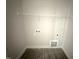 A tidy laundry room with a shelf and hookups for a washer and dryer at 612 Tuscany Cir, Princeton, NC 27569