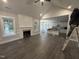 Spacious living room with hardwood floors, fireplace, and open layout to kitchen at 612 Tuscany Cir, Princeton, NC 27569
