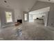 Bright living room with fireplace and large windows, seamlessly connecting to the modern kitchen and dining areas at 612 Tuscany Cir, Princeton, NC 27569