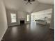 An open-concept living room with a fireplace, hardwood floors, and bright windows at 612 Tuscany Cir, Princeton, NC 27569