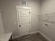 Neutral mud room with bench seating, utility hookups, and a door at 612 Tuscany Cir, Princeton, NC 27569