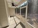 View of a screened-in patio with a ceiling fan, providing a comfortable outdoor living space at 612 Tuscany Cir, Princeton, NC 27569