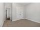 Bedroom featuring closet and hallway, with neutral carpet and wall colors at 613 Tuscany Cir, Princeton, NC 27569