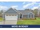 Charming home featuring a blue exterior, shingle accents, a two-car garage, and a well-maintained lawn at 613 Tuscany Cir, Princeton, NC 27569