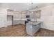 Modern kitchen featuring gray cabinets, stainless steel appliances, and a convenient center island at 613 Tuscany Cir, Princeton, NC 27569