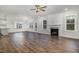 Bright living room with a cozy fireplace, wood-look flooring, and abundant natural light at 613 Tuscany Cir, Princeton, NC 27569