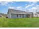 The rear exterior of the home features blue siding, trimmed windows, and a screened in porch at 613 Tuscany Cir, Princeton, NC 27569