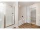 Well-lit bathroom showcasing a shower with glass door and a separate soaking tub with chrome fixtures at 65 Barony Ln, Smithfield, NC 27577