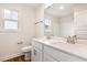 Bathroom with a double sink vanity, quartz countertop, window, and a built-in shower at 65 Barony Ln, Smithfield, NC 27577