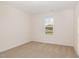Empty bedroom with neutral carpet, single window, and base molding at 65 Barony Ln, Smithfield, NC 27577