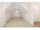 Angled bedroom with neutral carpet, dormer window and access to additional storage space at 65 Barony Ln, Smithfield, NC 27577