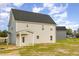 Exterior side view of the home showing a covered porch and a spacious lawn at 65 Barony Ln, Smithfield, NC 27577