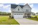 Charming two-story home with a two-car garage, complemented by a well-manicured lawn at 65 Barony Ln, Smithfield, NC 27577