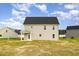 Rear exterior of the home featuring a covered porch and large backyard with neighborhood views at 65 Barony Ln, Smithfield, NC 27577