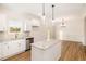 A well-lit kitchen with modern appliances, granite countertops, and wood-look floors at 65 Barony Ln, Smithfield, NC 27577