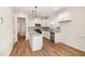 A well-lit kitchen with modern appliances, granite countertops, and wood-look floors at 65 Barony Ln, Smithfield, NC 27577