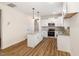 A well-lit kitchen with modern appliances, granite countertops, and wood-look floors at 65 Barony Ln, Smithfield, NC 27577