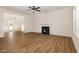 A well-lit living room with a fireplace and wood-look floors at 65 Barony Ln, Smithfield, NC 27577
