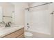 Bright bathroom featuring a granite countertop, vanity, and shower-tub combination at 68 Tee Dr, Selma, NC 27576